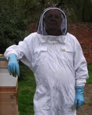 Photo of a beekeeper in all his regalia!